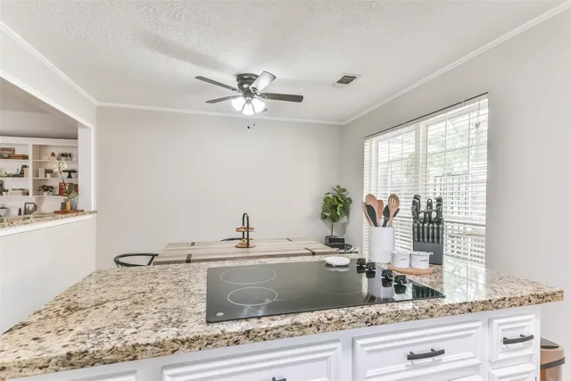 a kitchen with stainless steel appliances granite countertop a stove a sink and a microwave