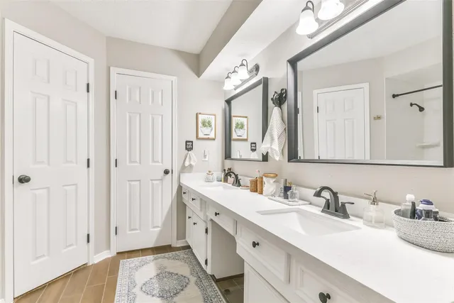 a bathroom with a double vanity sink mirror and