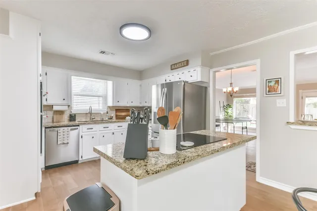 a kitchen with a sink cabinets and window