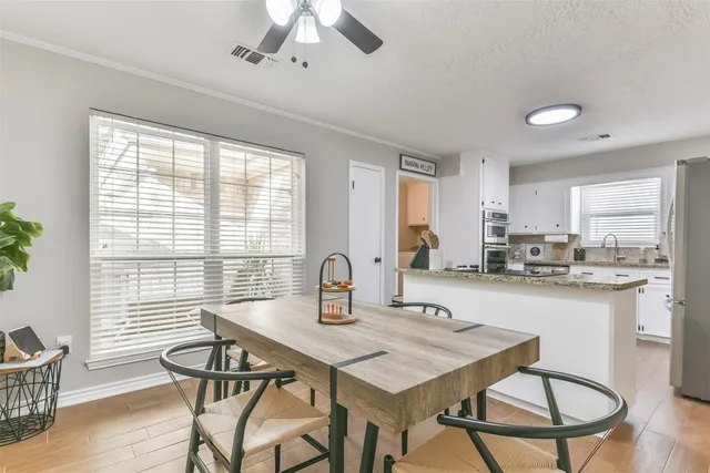 a view of a dining room with furniture window and wooden floor