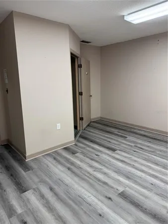 a view of a room with wooden floor