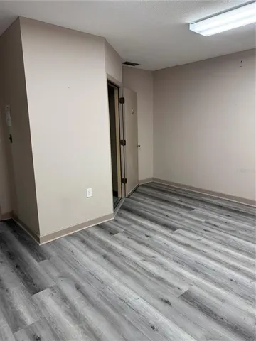 a view of a room with wooden floor