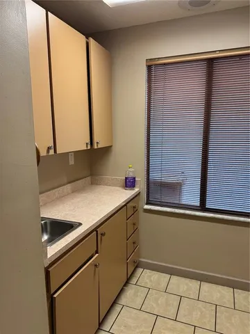 a kitchen with a sink and a window