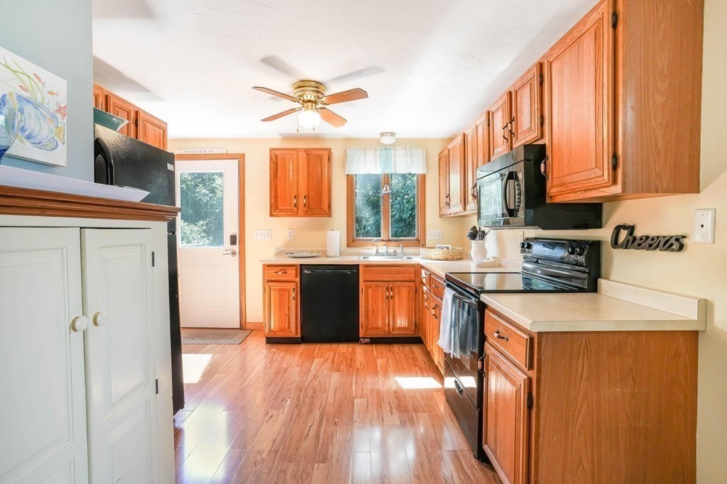 24 Jae Road Falmouth, MA 02556 - Photo 14 of 32 a kitchen with stainless steel appliances granite countertop a stove a sink dishwasher and a refrigerator with wooden floor