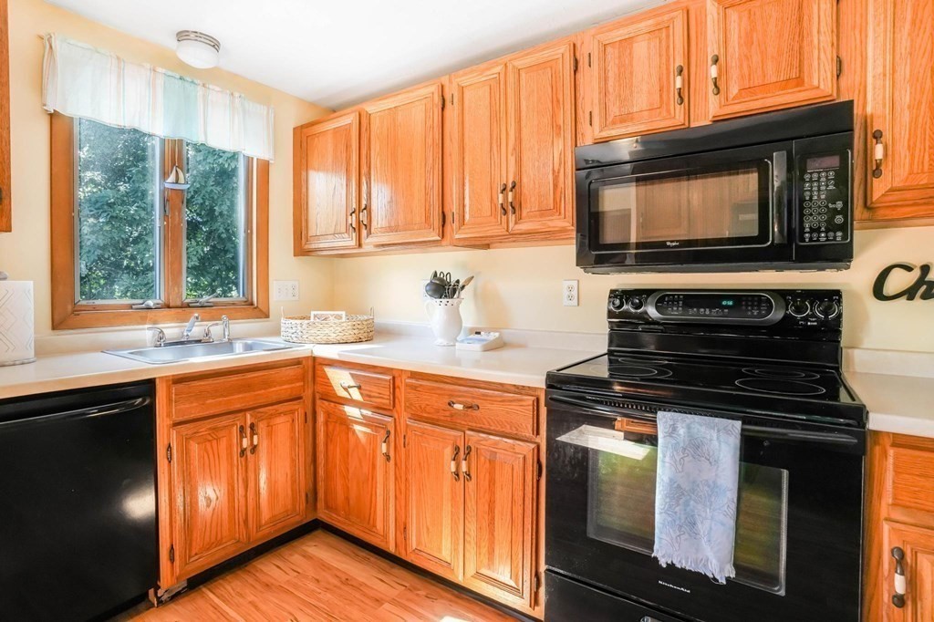 24 Jae Road Falmouth, MA 02556 - Photo 15 of 32 a kitchen with stainless steel appliances granite countertop a stove microwave and sink