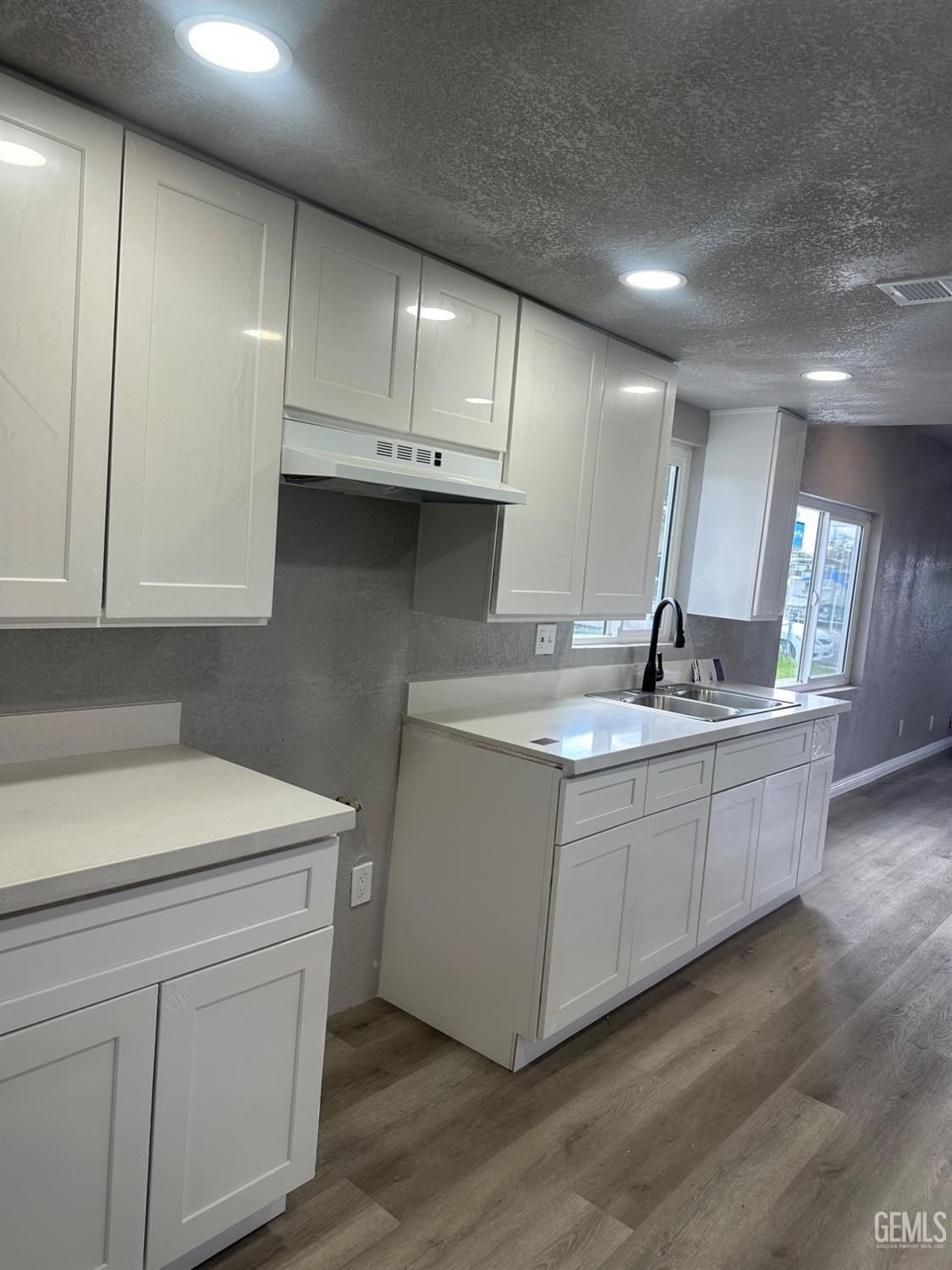 Undisclosed Address Delano, CA 93215 - Photo 11 of 13 a kitchen with sink cabinets and wooden floor