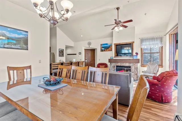 a living room with furniture a chandelier and a dining room