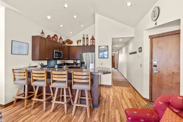 a dining room with furniture and wooden floor