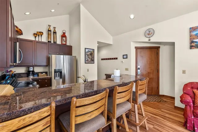a kitchen with stainless steel appliances kitchen island granite countertop a sink and cabinets
