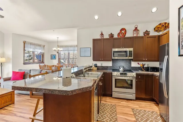 a kitchen with kitchen island granite countertop a sink and stove