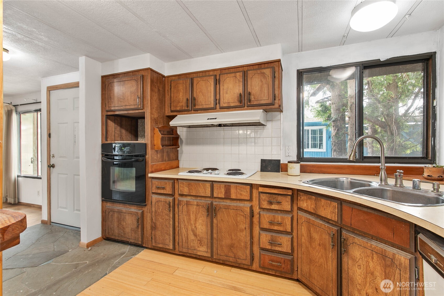 4015 Eliza Avenue, Unit 120 Bellingham, WA 98226 - Photo 13 of 26 a kitchen with stainless steel appliances granite countertop a refrigerator and a sink