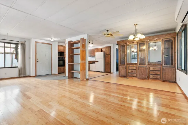 a view of a big room with chandelier cabinet and windows