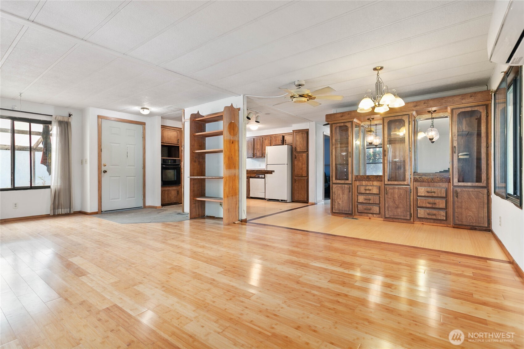 4015 Eliza Avenue, Unit 120 Bellingham, WA 98226 - Photo 4 of 26 a view of a big room with chandelier cabinet and windows
