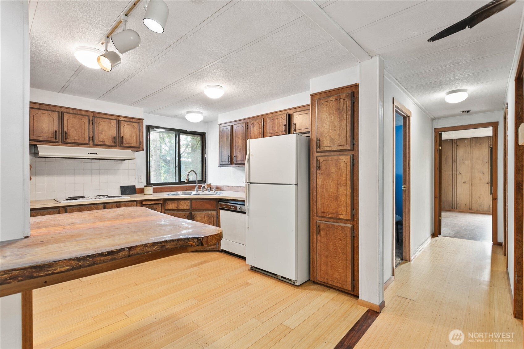4015 Eliza Avenue, Unit 120 Bellingham, WA 98226 - Photo 10 of 26 a kitchen with granite countertop a refrigerator and a sink