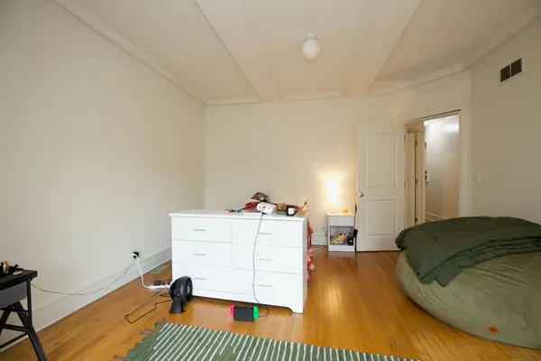 a bedroom with a bed and a dresser