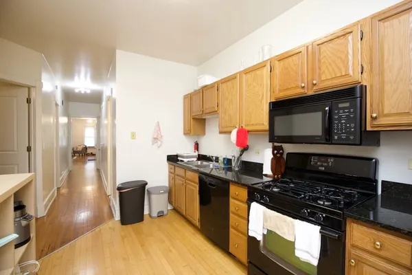 a kitchen with stainless steel appliances a stove a microwave a sink and cabinets