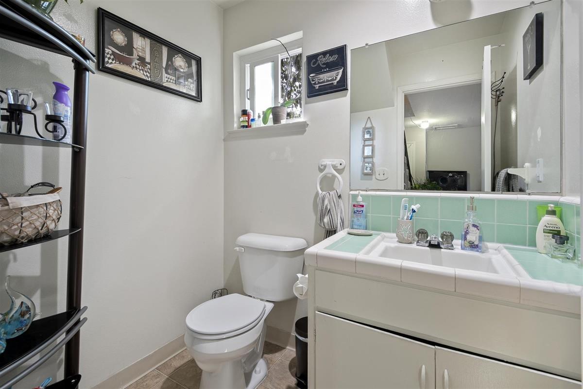 1367-1371 South Wolfe Road Sunnyvale, CA 94087 - Photo 17 of 47 a bathroom with a toilet sink and mirror
