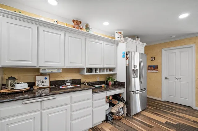 a kitchen with stainless steel appliances a refrigerator and cabinets