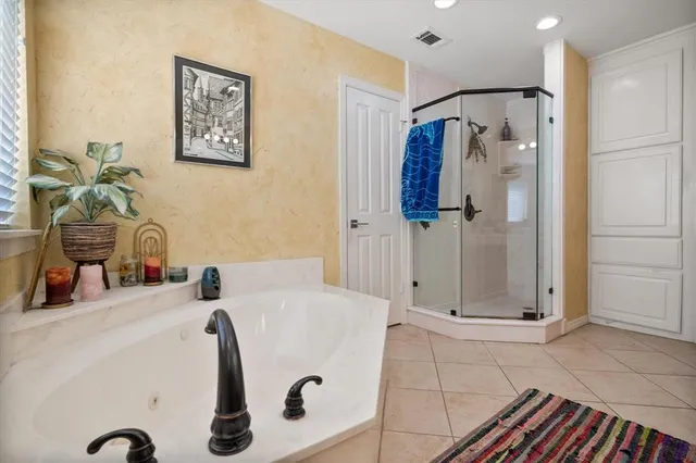 a bathroom with a tub and shower