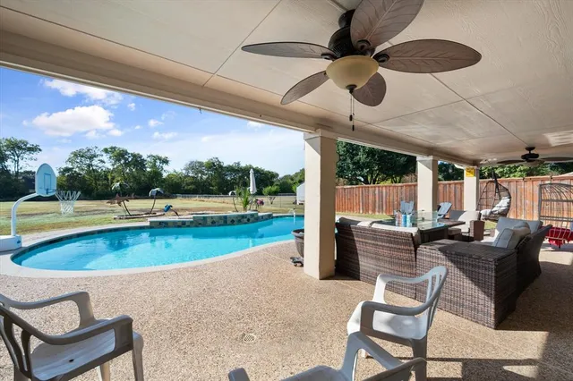 a view of a patio with swimming pool table and chairs