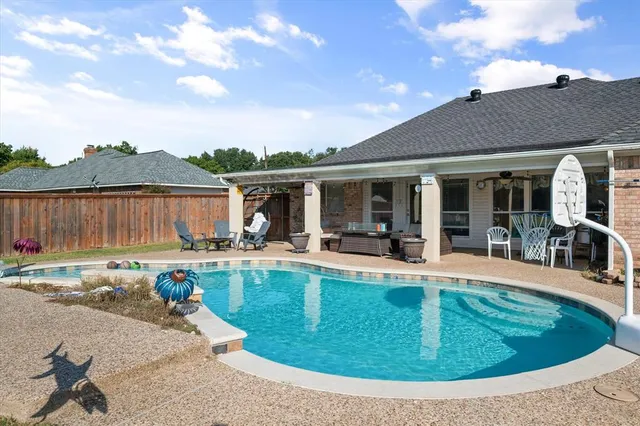 a view of a house with swimming pool and sitting area
