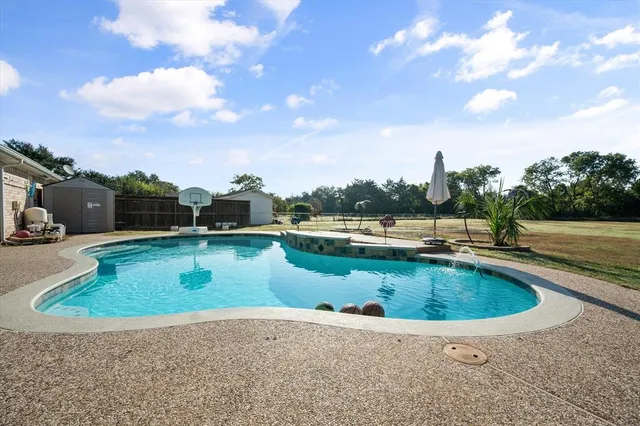 a view of a swimming pool with a yard