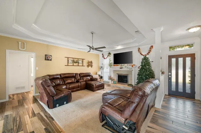 a living room with furniture a fireplace and a flat screen tv