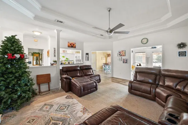 a living room with furniture and a chandelier