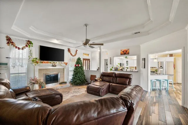 a living room with furniture a flat screen tv and a fireplace