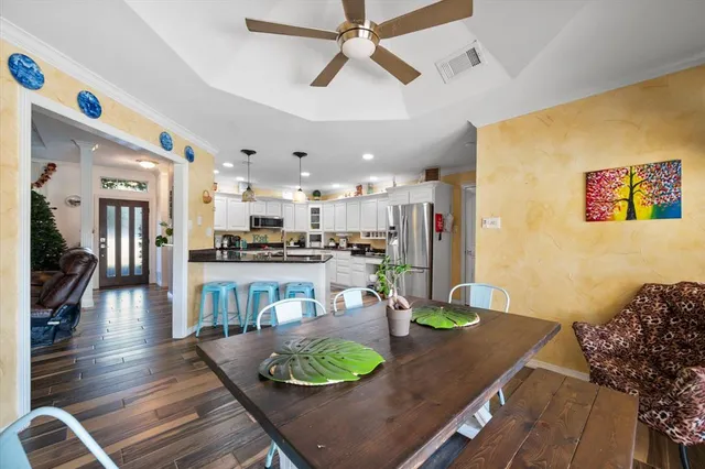 a kitchen with stainless steel appliances granite countertop a refrigerator a stove and a sink