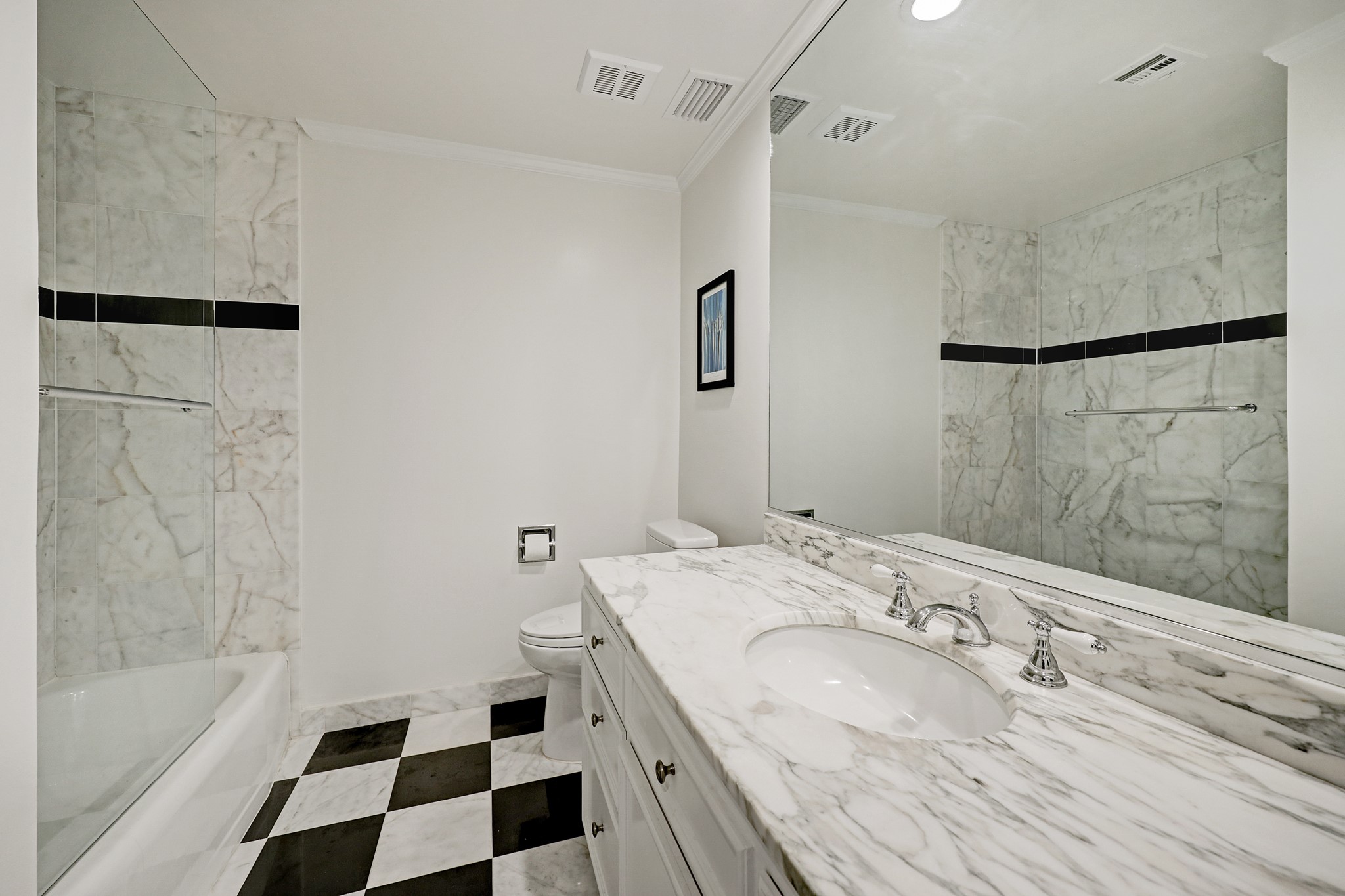 2200 Willowick Road, Unit 4E Houston, TX 77027 - Photo 11 of 17 a bathroom with a granite countertop sink a toilet a shower and a mirror