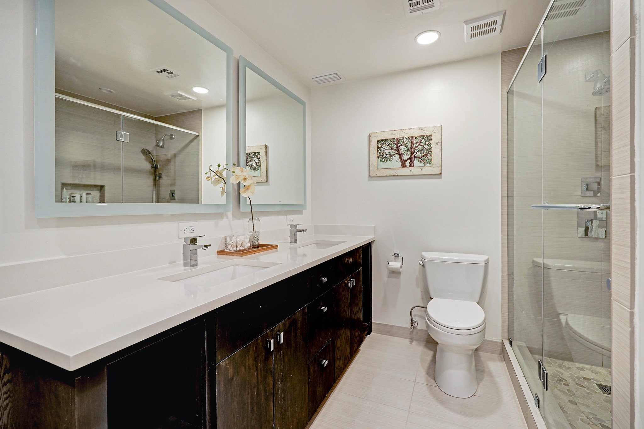2200 Willowick Road, Unit 4E Houston, TX 77027 - Photo 13 of 17 a bathroom with a toilet sink double vanity and mirror