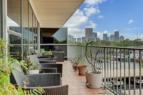 a view of a roof deck with couches and wooden floor