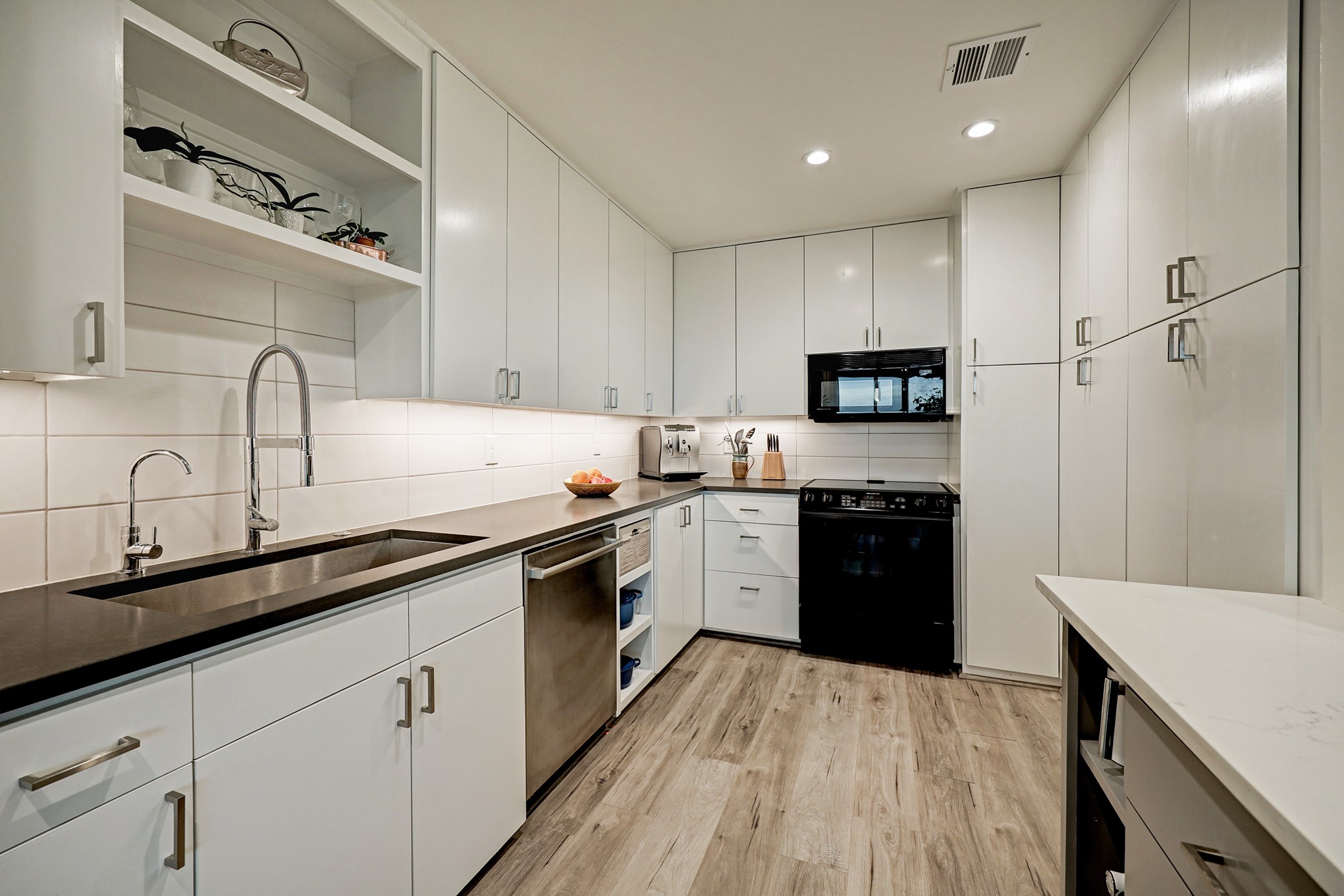 2200 Willowick Road, Unit 4E Houston, TX 77027 - Photo 8 of 17 a kitchen with granite countertop a sink stainless steel appliances and cabinets