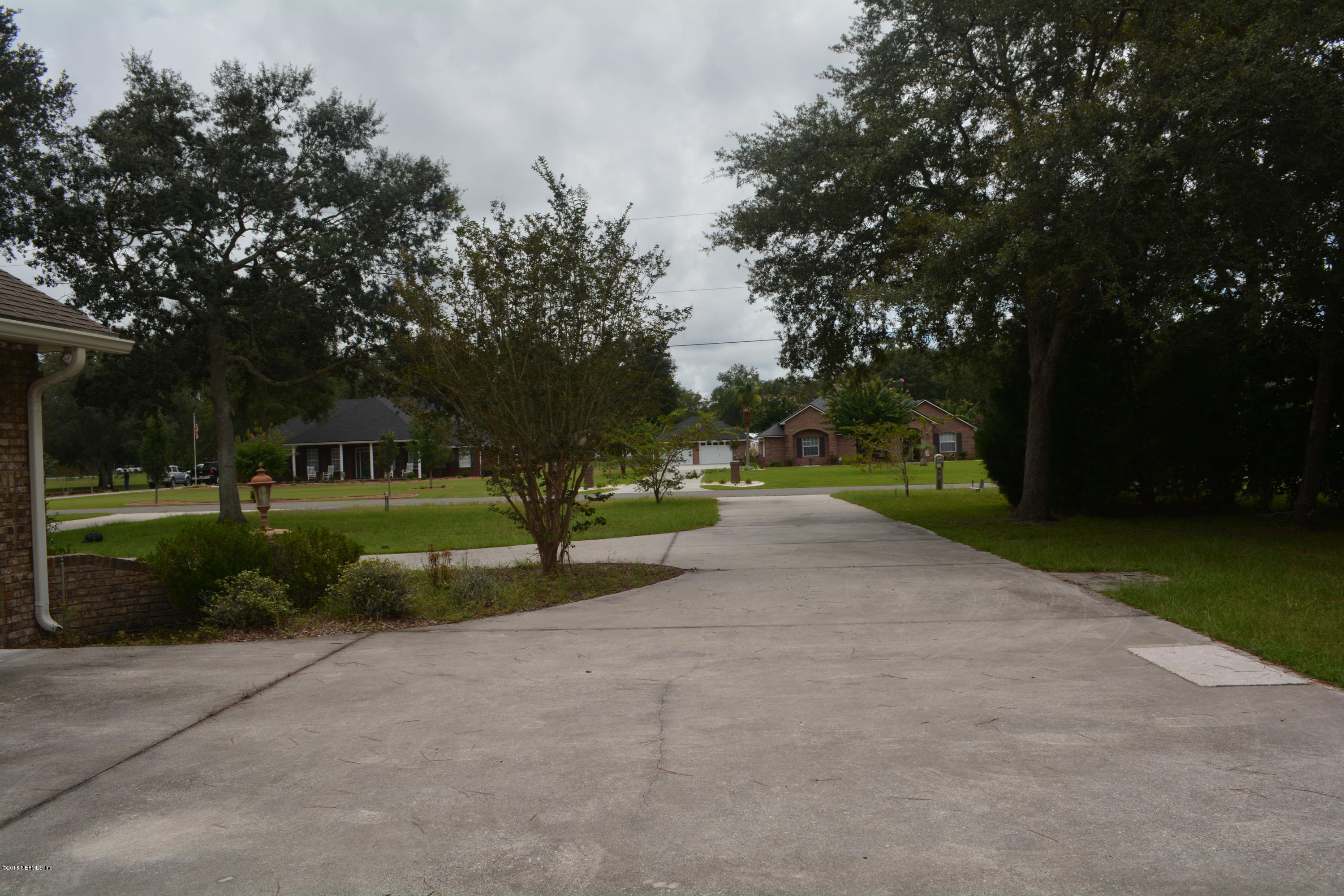4203 Raintree Drive Macclenny, FL 32063 - Photo 6 of 26 Driveway out to neighborhood