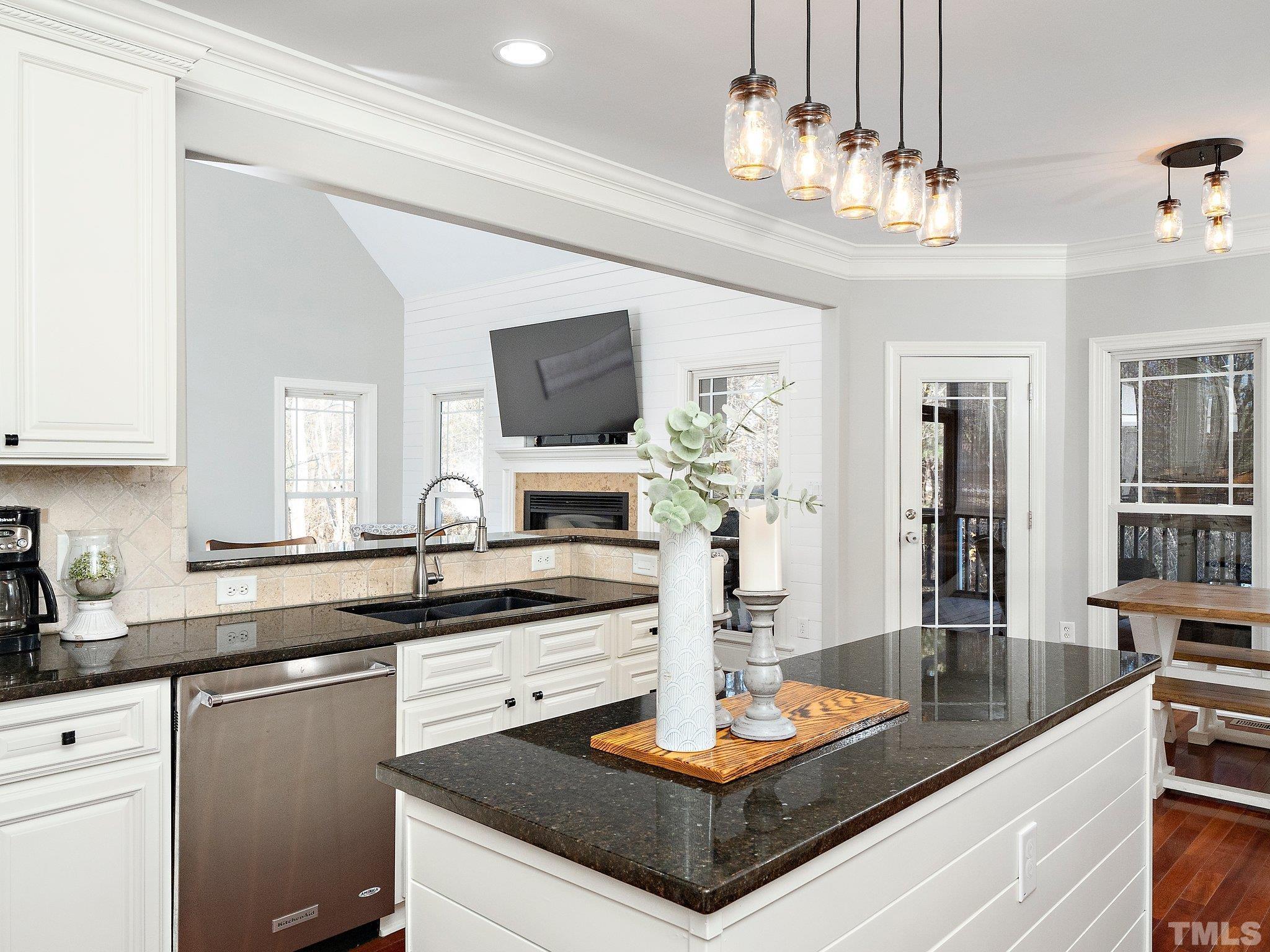2717 Peachleaf Street Raleigh, NC 27614 - Photo 15 of 42 a kitchen with stainless steel appliances granite countertop a sink and cabinets