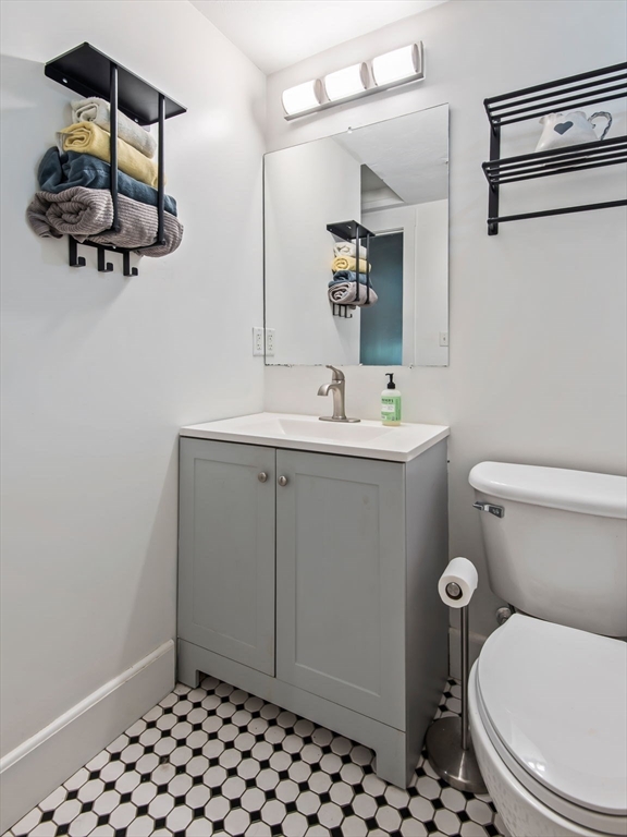 28 Adams Street, Unit 102 Worcester, MA 01604 - Photo 21 of 34 a bathroom with a sink a toilet and mirror