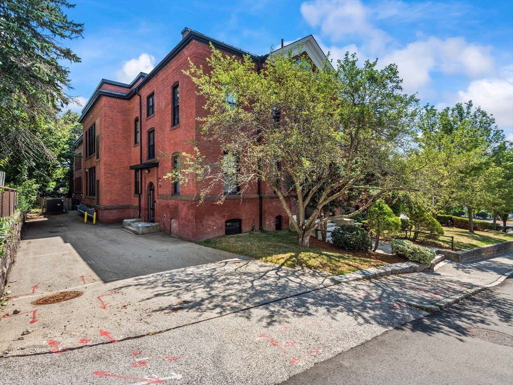 28 Adams Street, Unit 102 Worcester, MA 01604 - Photo 30 of 34 front view of a house with a yard
