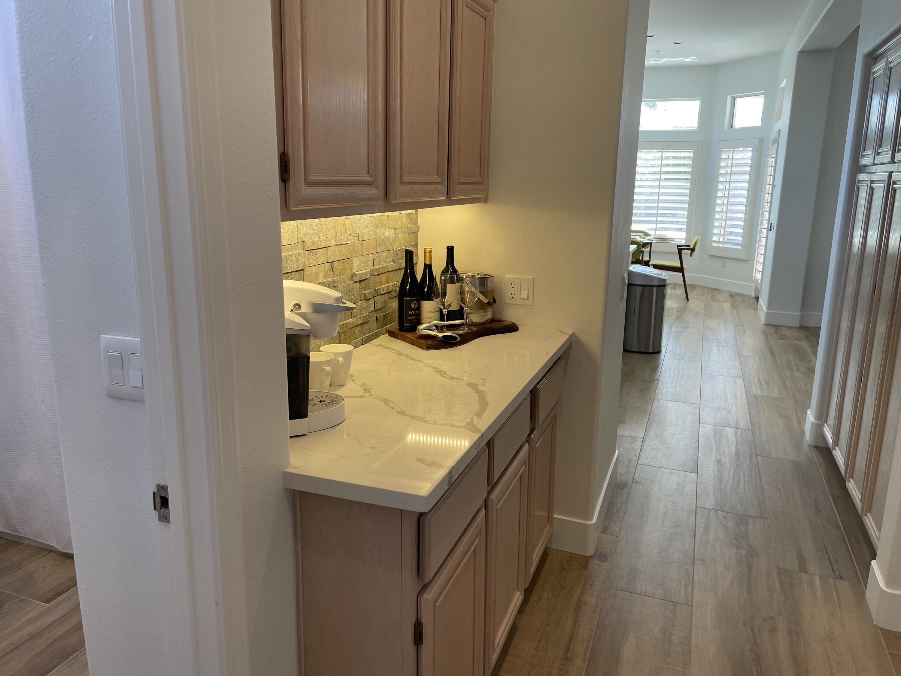 38286 Brandywine Avenue Palm Desert, CA 92211 - Photo 13 of 22 a kitchen with a sink and wooden cabinets