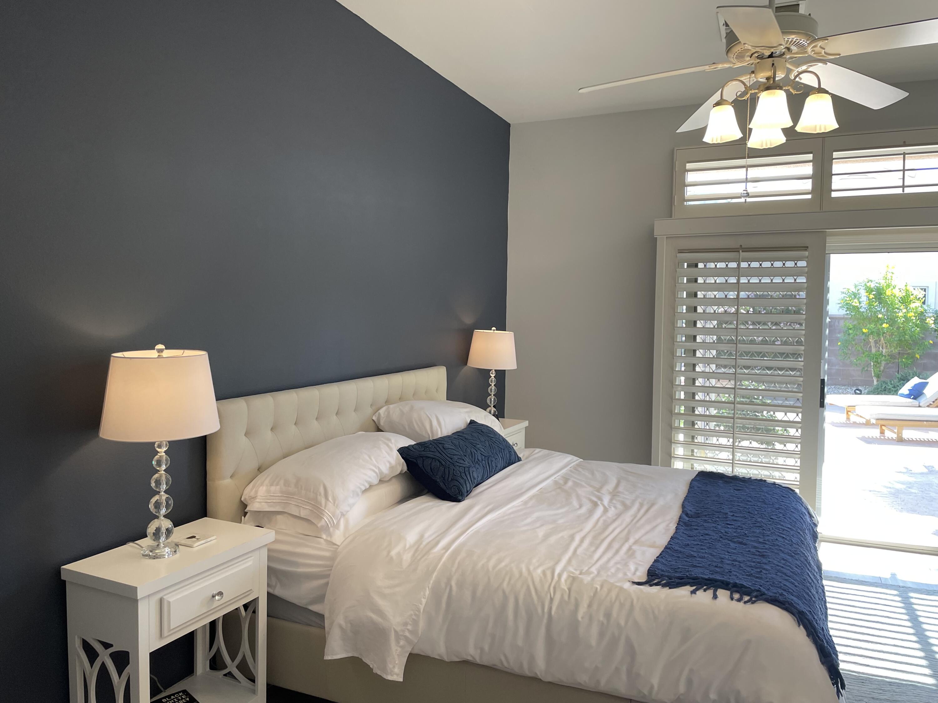 38286 Brandywine Avenue Palm Desert, CA 92211 - Photo 16 of 22 a bedroom with a bed and a chandelier