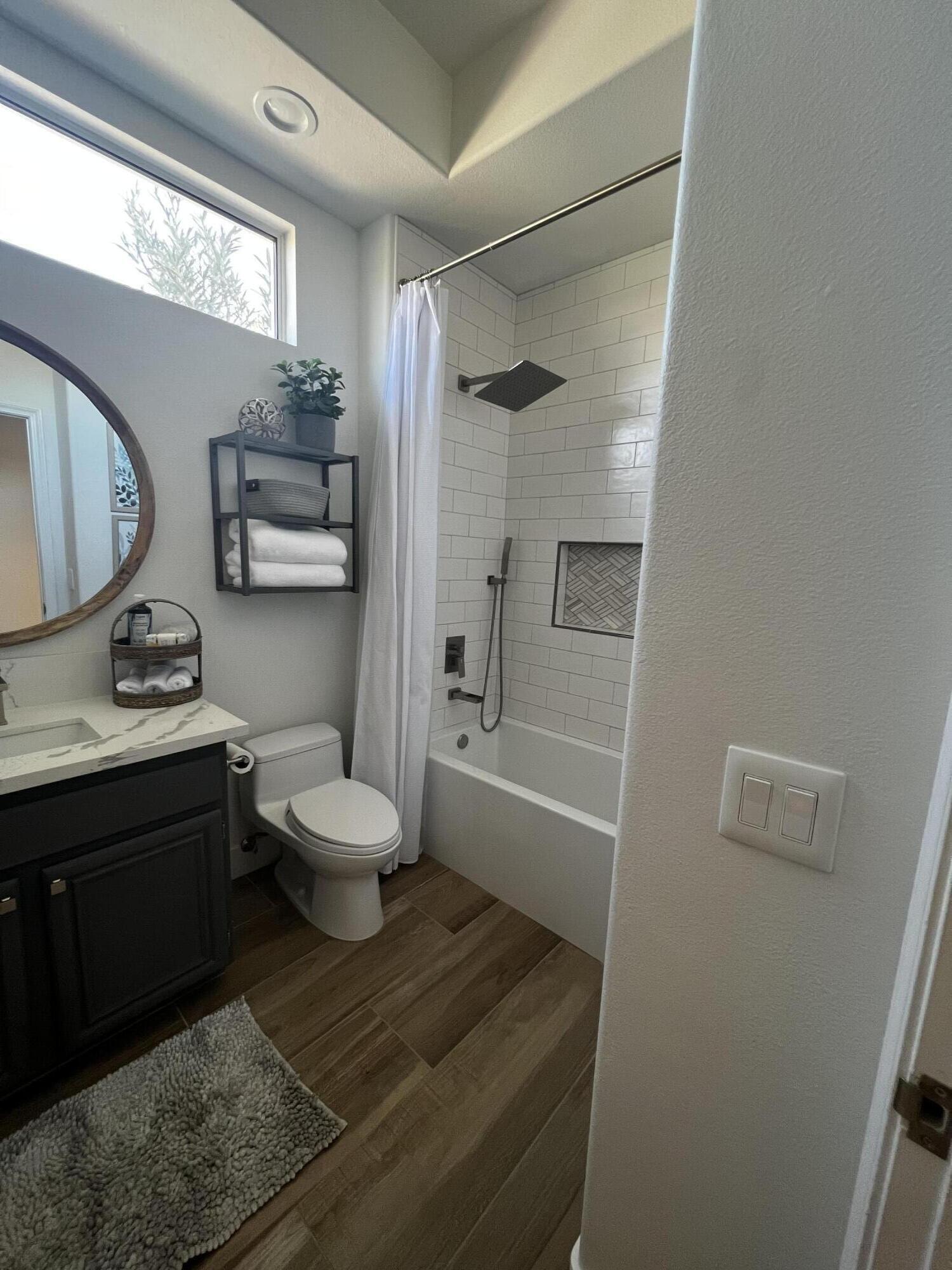 38286 Brandywine Avenue Palm Desert, CA 92211 - Photo 18 of 22 a bathroom with a granite countertop sink toilet a mirror and shower