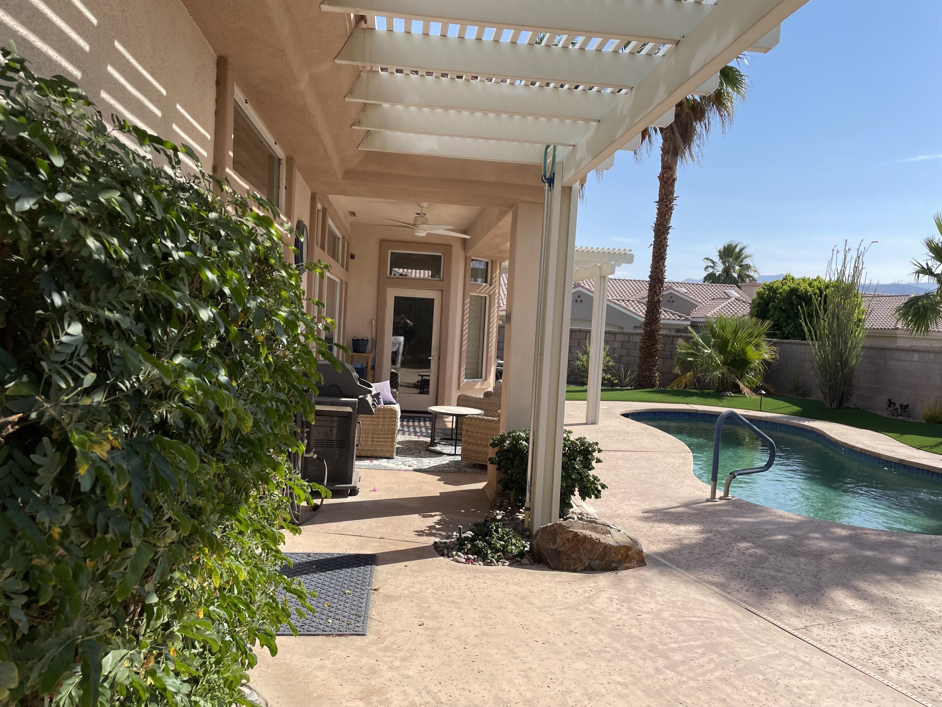 38286 Brandywine Avenue Palm Desert, CA 92211 - Photo 20 of 22 a view of swimming pool with outdoor seating and plants