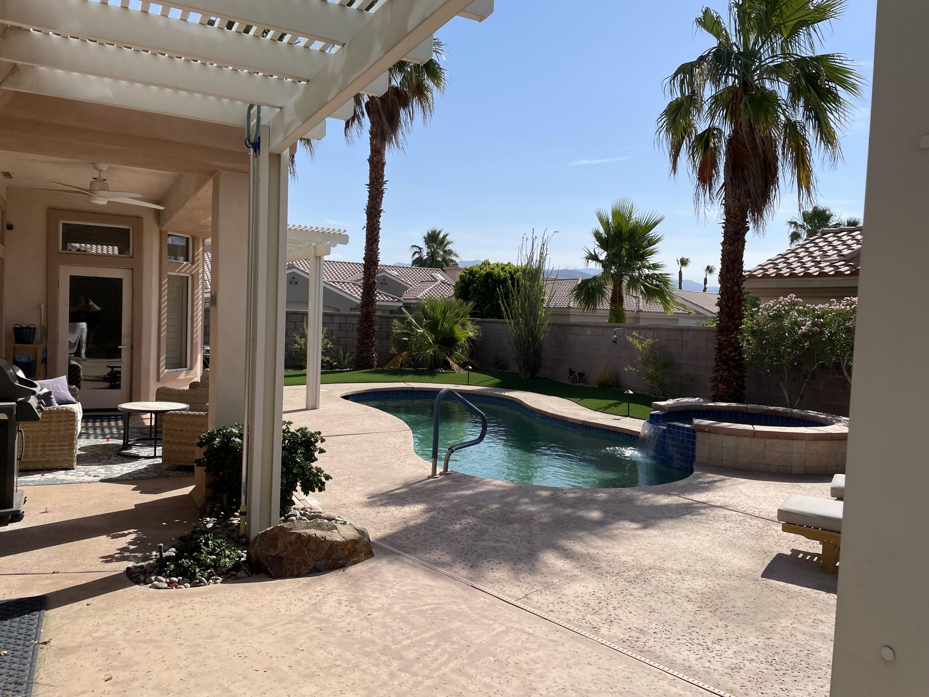 38286 Brandywine Avenue Palm Desert, CA 92211 - Photo 21 of 22 a view of swimming pool with a patio and a yard