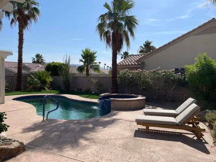 a view of swimming pool with a table and chairs