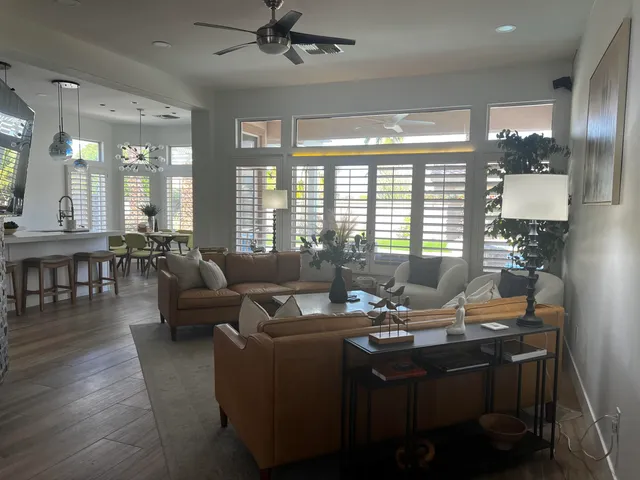a living room with furniture and floor to ceiling windows