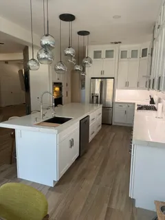a kitchen with a sink a counter space and stainless steel appliances