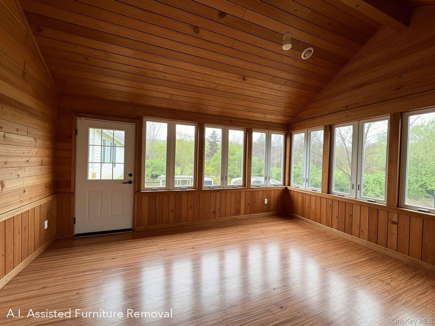 94 Booth Road Chester, NY 10918 - Photo 8 of 21 Different angle of door to deck from insulated, wood-paneled three season room featuring a pellet stove, an angled vaulted ceiling with recessed lighting, a ceiling fan, and extensive wrap around windows with roller shades.