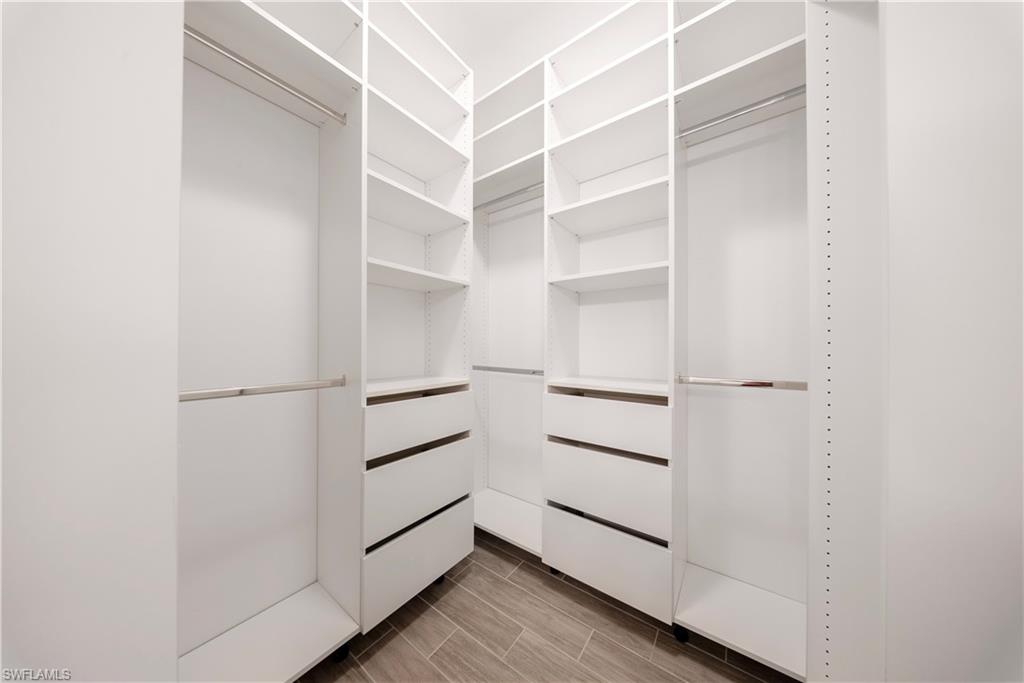 1059 Enbrook Loop Naples, FL 34114 - Photo 14 of 40 Walk in closet featuring wood finish floors