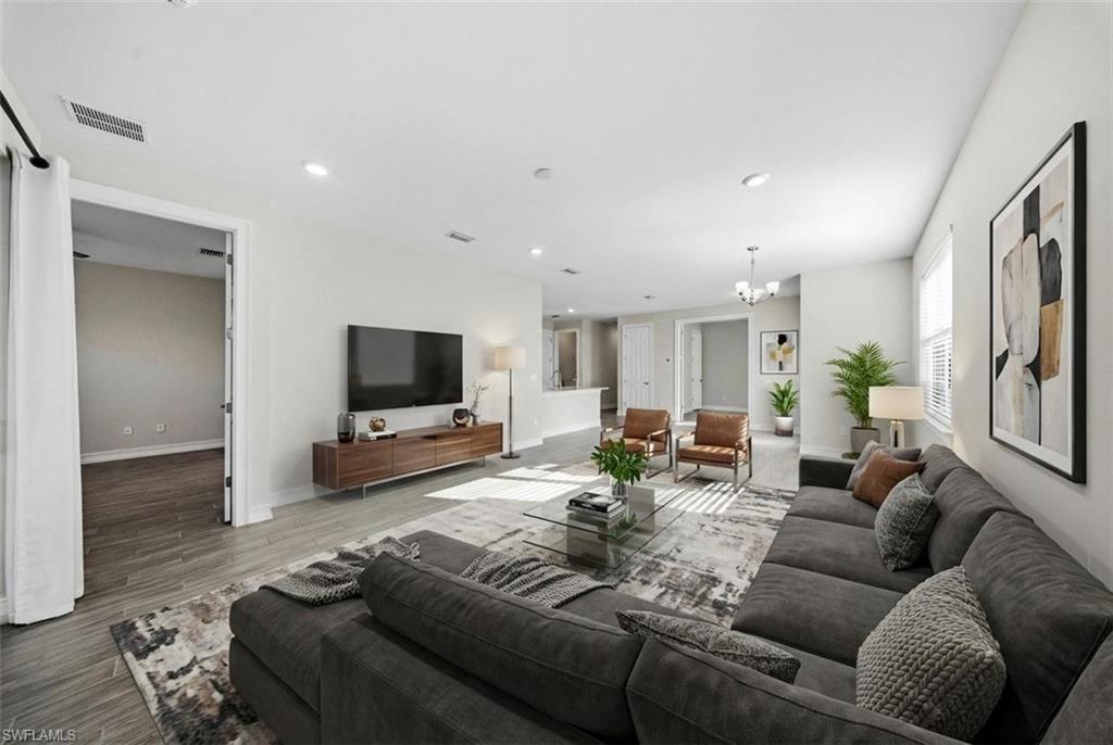 1059 Enbrook Loop Naples, FL 34114 - Photo 18 of 40 Living room featuring hanging lights and wood finished floors