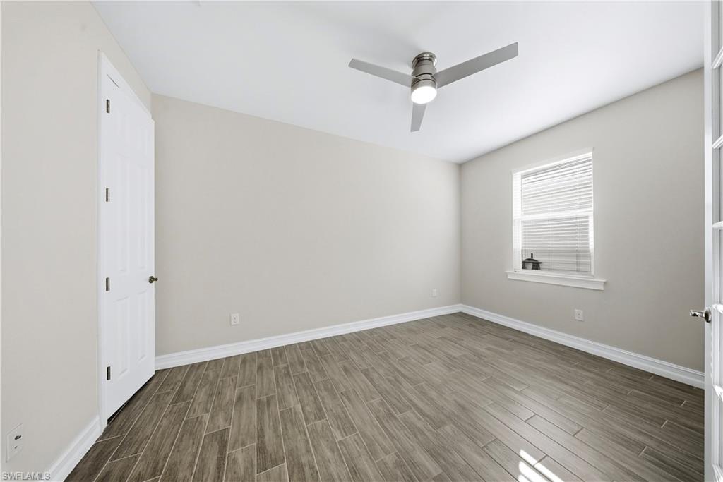 1059 Enbrook Loop Naples, FL 34114 - Photo 19 of 40 Spare room with wood tiled floors and ceiling fan